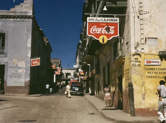 Framed Print : Street in San Juan Puerto Rico where many business advertise with Coca Cola signs. Dec. 1941