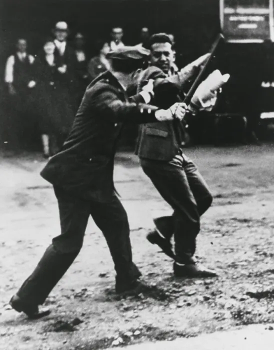Framed Print : A striker dodges policeman's night stick during San Francisco General Strikes. 1934