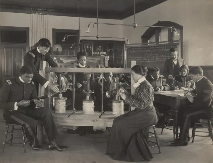 Framed Print : Students learning to operate a cheese press screw in agricultural sciences class, c. 1899-1900