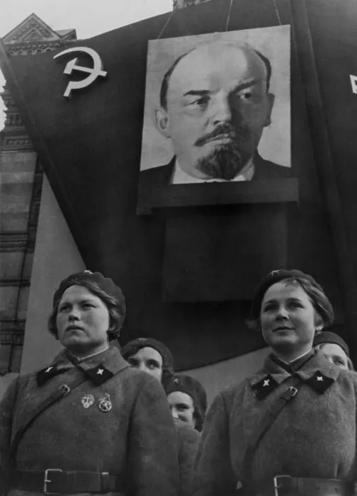 Framed Print : Students of the Military Communications Academy in Red Square, Moscow. Young women in military uniforms parade under a portrait of Lenin. 1930s photo by Georgii Zelma