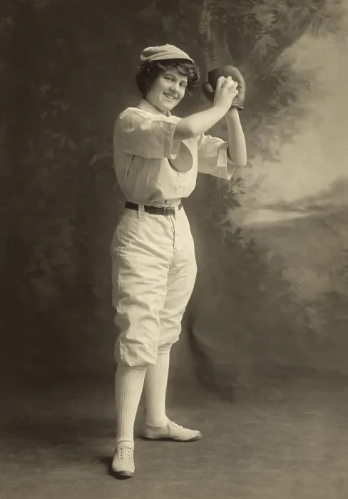 Framed Print : Studio portrait of a smiling young woman in pitching stance, wearing a baseball uniform, 1913