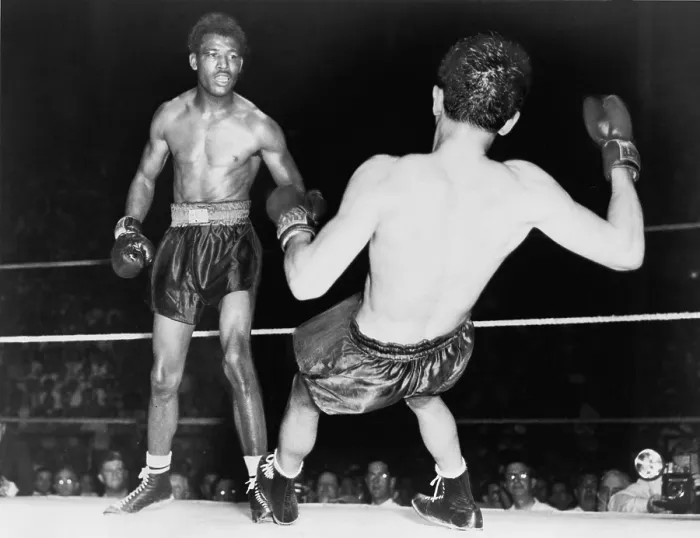 Framed Print : Sugar Ray Robinson (1921-1989) watching Jimmy Doyle fall backwards after receiving a knockout punch. Doyle later died of injuries from his fall. 1947 Framed Print : Sugar Ray Robinson (1921-1989) watching Jimmy Doyle fall backwards after receiving a knockout punch. Doyle later died of injuries from his fall. 1947