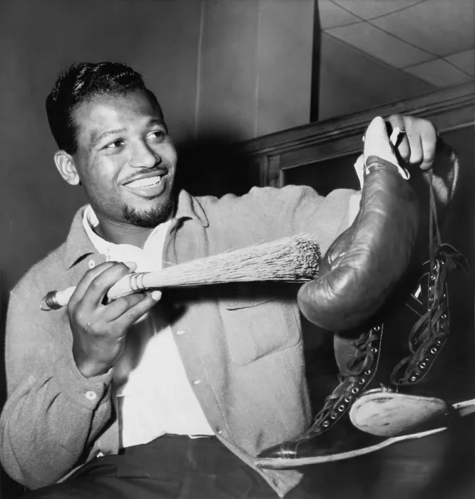 Framed Print : Sugar Ray Robinson dusting off his boxing gloves and shoes in a publicity photo for his 1954 comeback to professional boxing