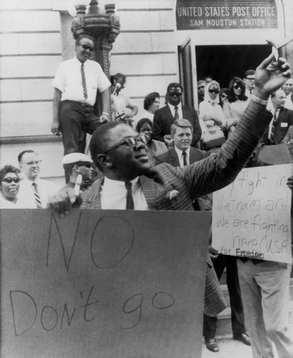 Framed Print : Supporters of Muhammad Ali, formerly Cassius Clay, cheer on a man burning draft card in Houston, Texas