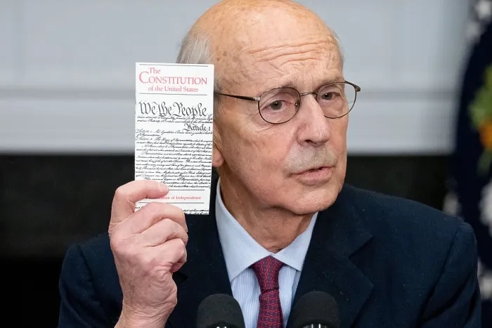 Framed Print : Supreme Court Justice Stephen Breyer holds a copy of the US Constitution as he speaks on his announcement of retirement, Jan. 27, 2022 (BSLOC_2022_2_27)