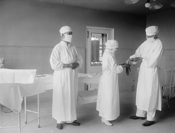 Framed Print : Surgical nurse assists surgeons into rubber gloves before an operation. 1922 in a hospital in Washington, D.C. (BSLOC_2016_10_32) Framed Print : Surgical nurse assists surgeons into rubber gloves before an operation. 1922 in a hospital in Washington, D.C. (BSLOC_2016_10_32)