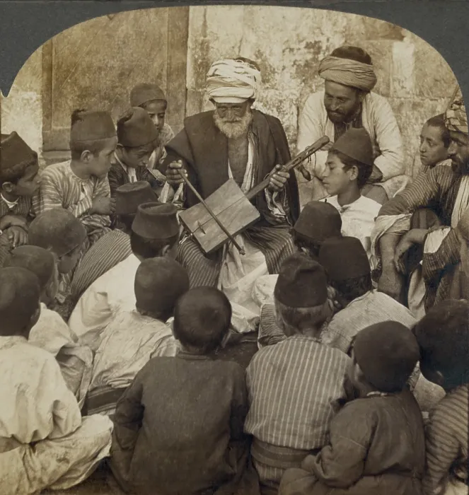 Framed Print : Syrian schoolboys gathered around a man with a Rababeh, a single string instrument with a square sound box played by a string bow. Ca. 1905 Framed Print : Syrian schoolboys gathered around a man with a Rababeh, a single string instrument with a square sound box played by a string bow. Ca. 1905