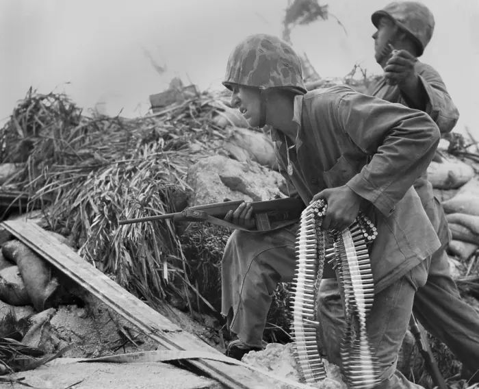 Framed Print : On Tarawa, a U.S. Marine, with a carbine and a bandolier of bullets. He waits for his buddy to toss a hand grenade, before he advances toward Japanese. Nov