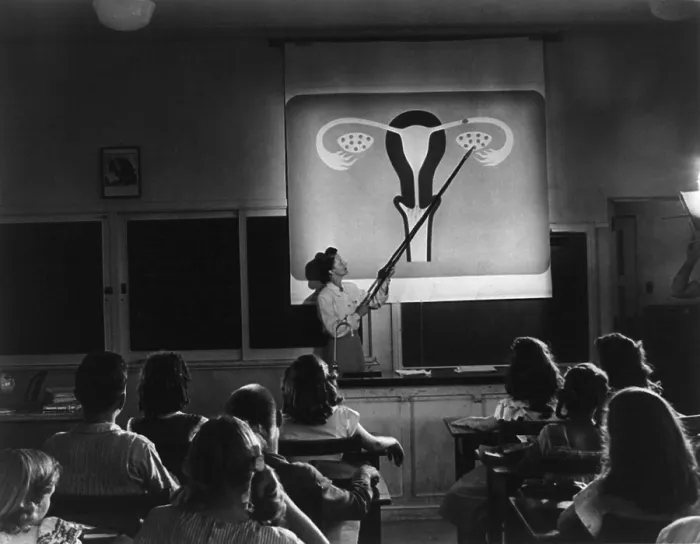 Framed Print : Teacher points to a diagram of female reproductive organs in a Sex Education class. The Oregon junior high students are viewing an educational film, HUMAN GROWTH, in 1948