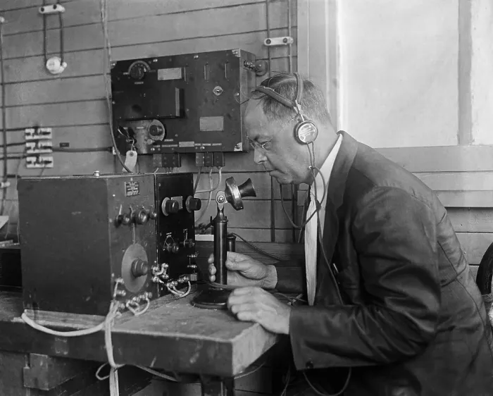 Framed Print : Technologist at the U.S. Naval Research Laboratory operating a telephone connected to electronic equipment. 1925