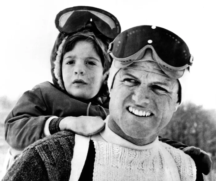 Framed Print : Ted Kennedy gives his nephew John F. Kennedy Jr. a piggy-back ride down the ski slopes in Stowe, Vermont. The Kennedy family spent Easter weekend skiing together. March 29, 1964