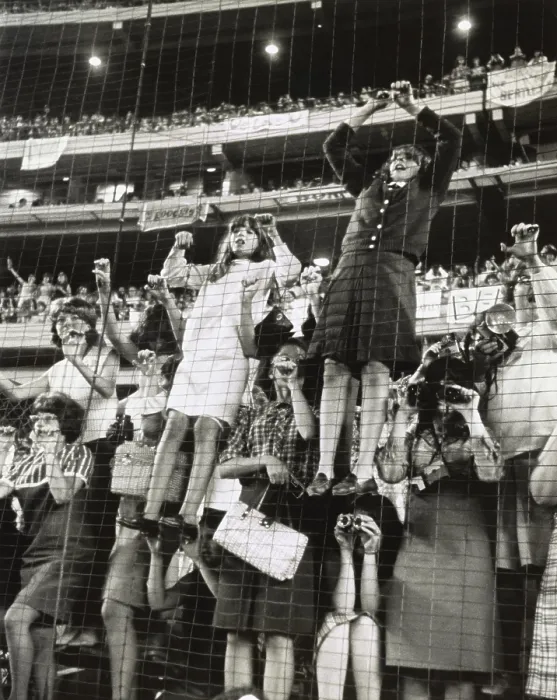 Framed Print : Teenage girls climb a wire fence to get a better view of the British singing group, the Beatles, at Shea Stadium, August 15, 1965