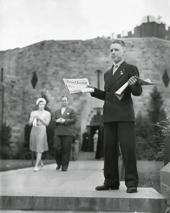 Framed Print : Teenager selling Father Coughlin's newspaper, Social Justice, July 1940. Behind him is the Shrine of the Little Flower Catholic Church, Detroit, Michigan