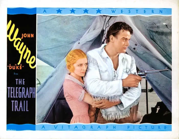 Framed Print : THE TELEGRAPH TRAIL, US lobbycard, from left: Marceline Day, John Wayne, 1933