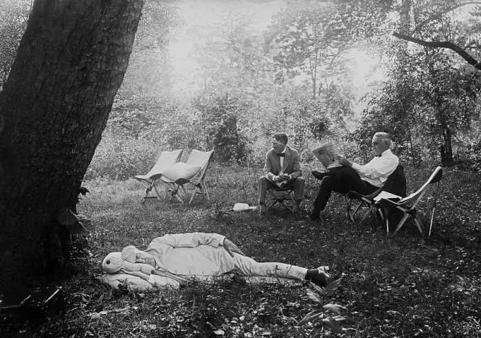 Framed Print : Thomas Edison naps under a tree, on July 19, 1921. In the background President Warren Harding reads a newspaper in a camp chair next to Harvey Firestone. Maryland Framed Print : Thomas Edison naps under a tree, on July 19, 1921. In the background President Warren Harding reads a newspaper in a camp chair next to Harvey Firestone. Maryland