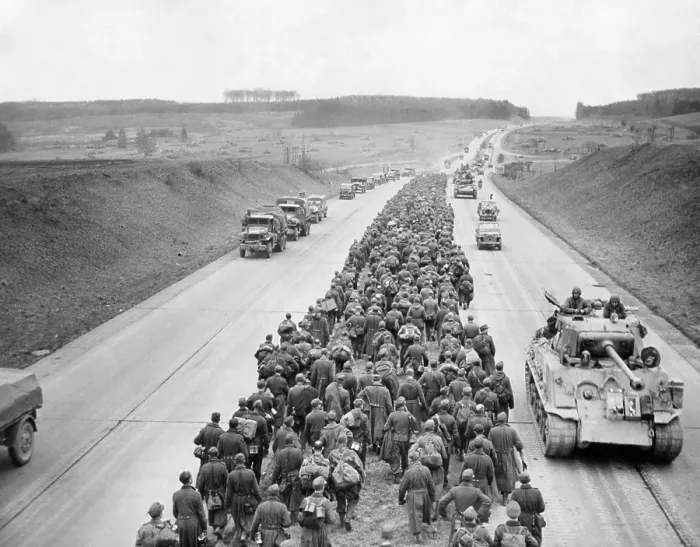 Framed Print : Thousands of German prisoners march along the Autobahn near Giesson, northwest of Frankfurt. In the opposite direction American tanks and vehicles advance to the battlefront