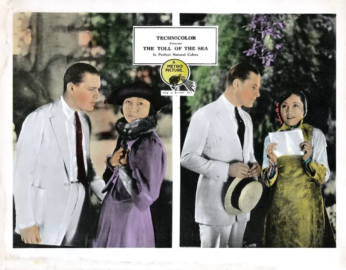 Framed Print : THE TOLL OF THE SEA, Kenneth Harlan (white suit), Anna May Wong (purple, and right), 1922