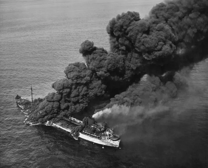 Framed Print : A torpedoed American tanker burning after an Axis submarine attack. Crew members brought the fire under control and the ship was towed to port for repair. Ca. 1942-43