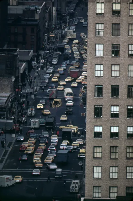 Framed Print : Traffic in New York City. View of vehicles on Manhattan's Sixth Avenue at 42nd Street is framed by a massive pre-war apartment building. Ca. 1973-75