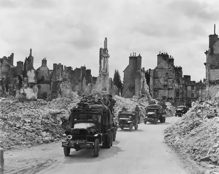 Framed Print : Trucks, some with U.S. soldiers standing in back, riding through the ruins Valognes, France. June-July 1944. Normandy Campaign, World War 2. (BSLOC_2014_2_129) Framed Print : Trucks, some with U.S. soldiers standing in back, riding through the ruins Valognes, France. June-July 1944. Normandy Campaign, World War 2. (BSLOC_2014_2_129)