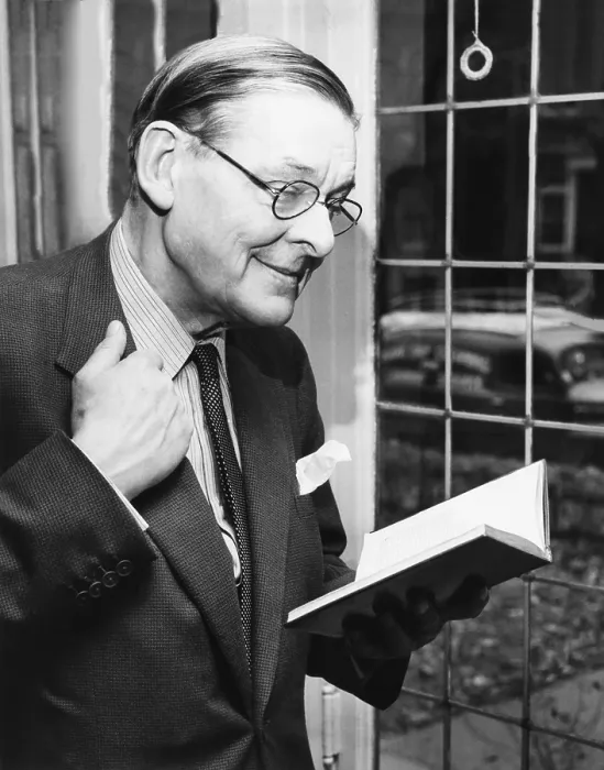 Framed Print : T.S. Eliot, smiling in reminiscence, Nov. 10, 1959. He is holding a book containing some of his early works during a press conference at the University of Chicago