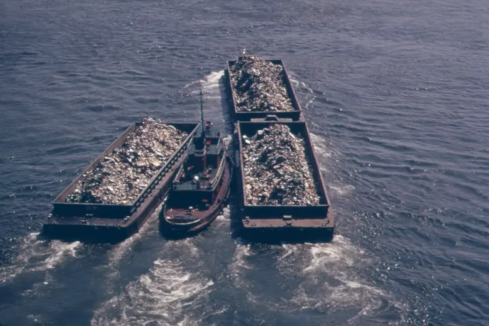Framed Print : Tug boats tow barges of garbage down the East River to an overflowing Staten Island landfill. In the early 1970s New York City produced 26 000 tons of solid waste daily. Ca