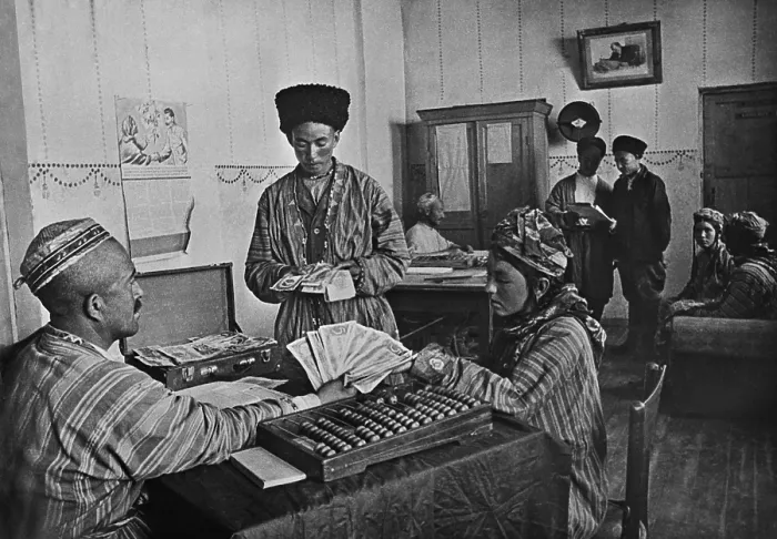 Framed Print : Turkmenian collective farmers receiving their share of yearly profits in the 1930s. The farm administrator calculates with an Abacus Framed Print : Turkmenian collective farmers receiving their share of yearly profits in the 1930s. The farm administrator calculates with an Abacus