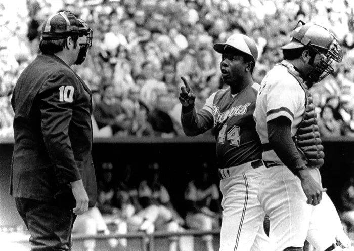 Framed Print : Umpire John McSherry listens to Hank Aaron argue a called third strike as catcher Johnny Bench looks down, 1974. Courtesy: CSU Archives  /  Everett Collection