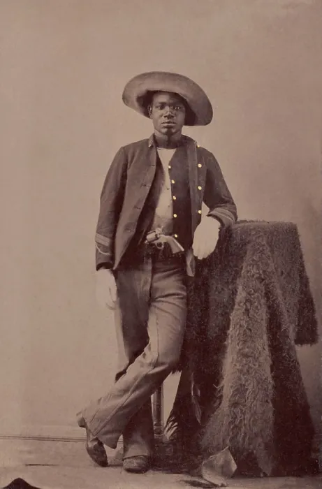 Framed Print : An unidentified Buffalo Soldier posing with a buffalo hide studio prop, c. 1860-1879 (BSLOC_2019_9_100) Framed Print : An unidentified Buffalo Soldier posing with a buffalo hide studio prop, c. 1860-1879 (BSLOC_2019_9_100)