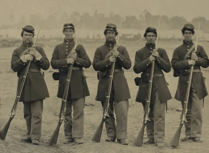 Framed Print : Five Union soldiers wear frock coat uniforms, as they stand at ease with their Enfield Rifles. An encampment is visible in the background