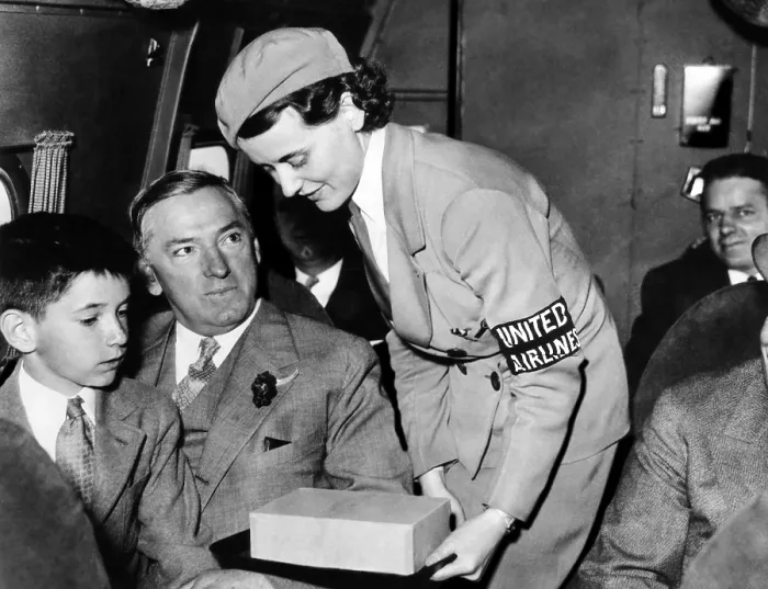 Framed Print : United Airlines stewardess assists Mayor James Curley of Boston. He went on to become the governor of Massachusetts, 1934. Courtesy: CSU Archives / Everett Collection