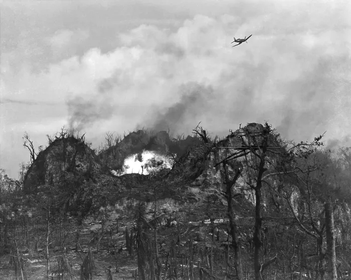 Framed Print : U.S. airplane drop bombs on the enemy area in the hills of Peleliu Island. Sept.-Nov. 1944. World War 2, Pacific Ocean. (BSLOC_2013_13_28)