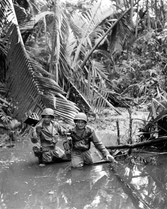 Framed Print : U.S. Army photographer, wading through a stream during an invasion at a beach in New Guinea