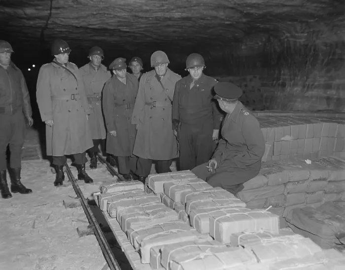 Framed Print : U.S. commanders tour German Merkers salt mine where Nazi treasure was hidden. Gen. Eisenhower is seated, with Gens. Patton and Bradley at left. Eisenhower is speaking to Gen Framed Print : U.S. commanders tour German Merkers salt mine where Nazi treasure was hidden. Gen. Eisenhower is seated, with Gens. Patton and Bradley at left. Eisenhower is speaking to Gen