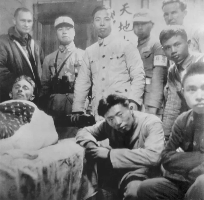 Framed Print : U.S. Doolittle Raider with his Chinese friends. An American flier, injured in a parachute jump after the April 8, 1942 air raid, lies on a cot in a Chinese home Framed Print : U.S. Doolittle Raider with his Chinese friends. An American flier, injured in a parachute jump after the April 8, 1942 air raid, lies on a cot in a Chinese home