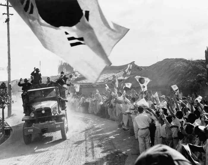 Framed Print : U.S. First Cavalry Division troops pass cheering Koreans north of Seoul on the way to the 38th parallel