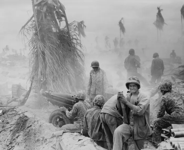 Framed Print : U.S. Marine artillery crew during the Battle of Tarawa. Standing beside the howitzer is a Marine with two bullet holes in his helmet. Nov. 20-23, 1943