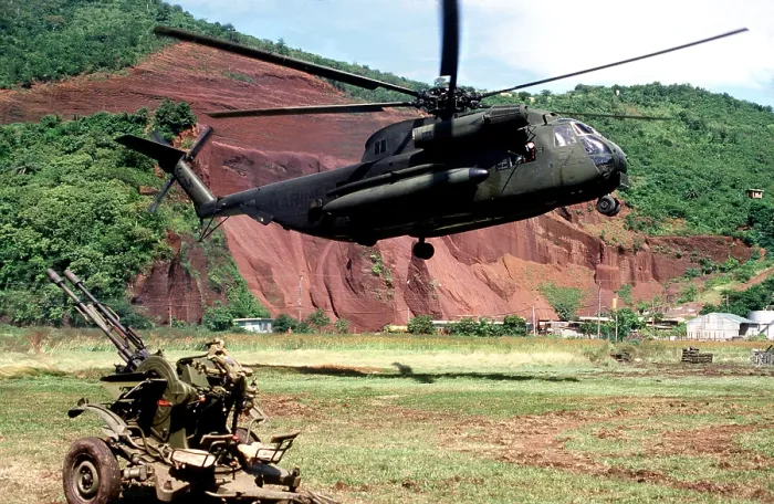 Framed Print : U.S. Marine Corps helicopter hovers near a Soviet anti-aircraft weapon during the U.S. invasion of Grenada in October 1983