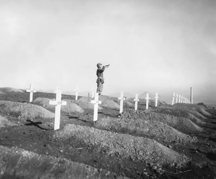 Framed Print : U.S. Marine plays Taps over the graves of fallen Leathernecks during memorial services
