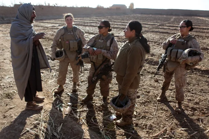 Framed Print : U.S. Marines in Afghanistan assigned to a female engagement team speak with a local Afghan man in his compound during a patrol in Marjah Helmand province Afghanistan. Dec