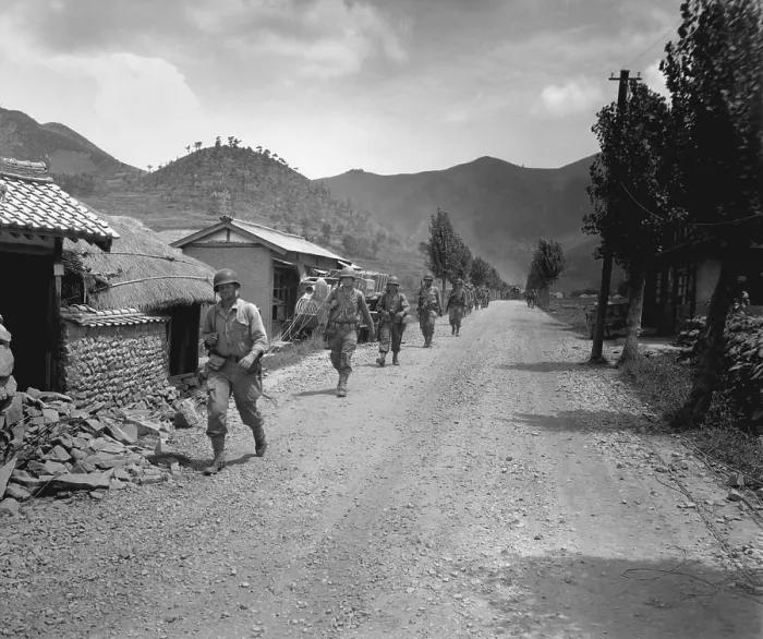 Framed Print : U.S. Marines pass through one of the many small, battered South Korean villages. They are moving up to meet the North Korean forces during the Battle of Pusan Perimeter