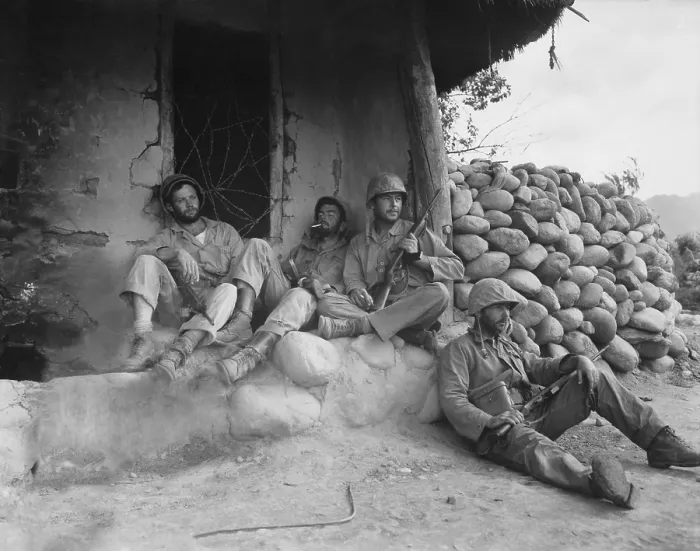 Framed Print : U.S. Marines relax after killing an enemy sniper housed in the Korean hut. Sept. 24, 1951. Korean War, 1950-53. (BSLOC_2014_11_114)