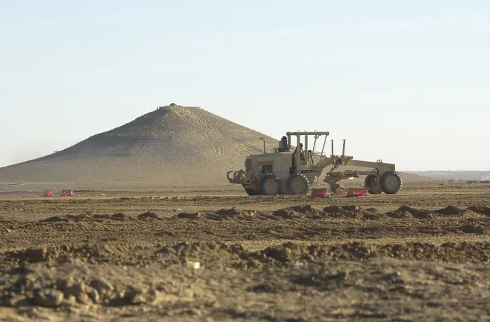 Framed Print : U.S. Navy Seabees run heavy graders down the runway to patch holes and remove excess dirt in the first weeks occupation of Kandahar on Dec. 18 2001