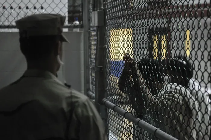 Framed Print : U.S. Sailor stands watch over a cell block at U.S Framed Print : U.S. Sailor stands watch over a cell block at U.S