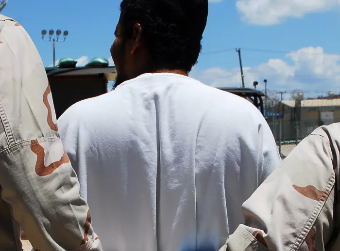 Framed Print : U.S. Sailors escort a detainee to an appointment at Camp 4 of the military prison at at Guantanamo Bay Naval Station Cuba