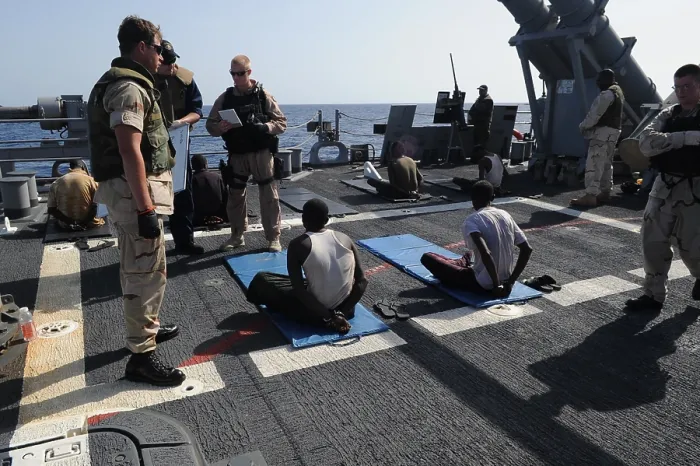 Framed Print : U.S. Sailors guard suspected pirates on the flight deck of the guided missile cruiser USS Gettysburg in the Gulf of Aden April 17 2009