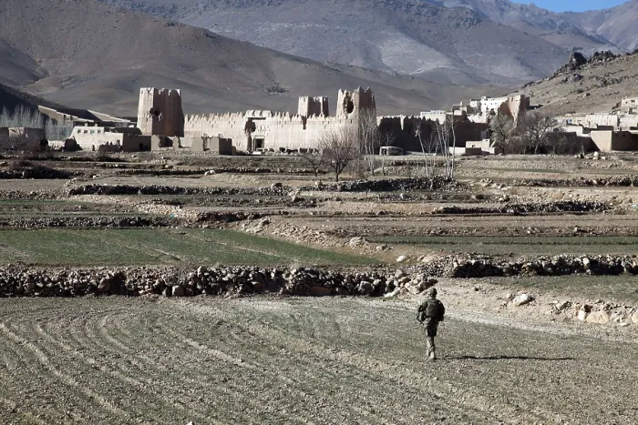 Framed Print : U.S. Soldier walks through a field to Dahanah village Wardak province Afghanistan. Dec. 2 2010. Photo by:Everett Collection(BSLOC_2011_6_62)