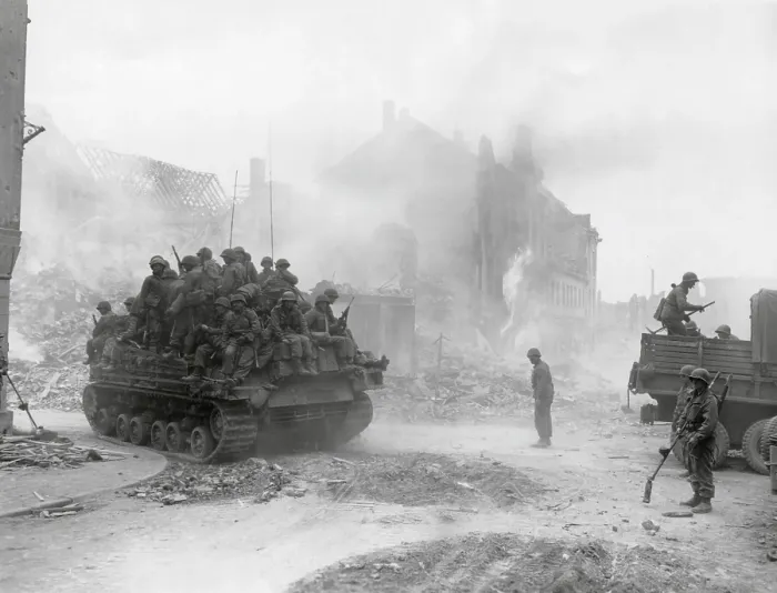 Framed Print : U.S. soldiers of the 3rd Division Infantry, packed on a tank in Zweibrucken, Germany. Minesweeping engineers stand by in the midst of smoking ruins of the industrial city Framed Print : U.S. soldiers of the 3rd Division Infantry, packed on a tank in Zweibrucken, Germany. Minesweeping engineers stand by in the midst of smoking ruins of the industrial city