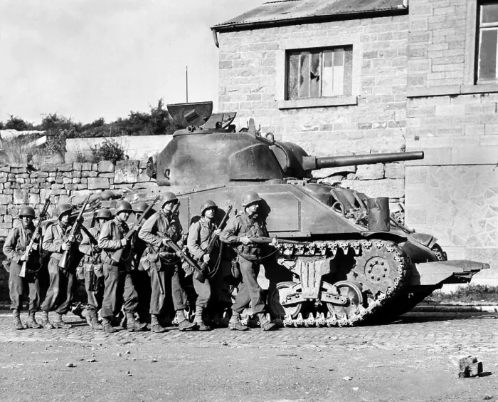 Framed Print : U.S. soldiers advance into a Belgian town under the protection of a heavy tank. Sept. 9, 1944 during World War 2. (BSLOC_2014_2_171)