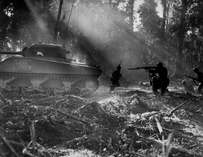 Framed Print : U.S. soldiers advance in the cover of a tank on Bougainville, March 1944. At night Japanese troops would infiltrate American lines. At dawn doughboys would clear them out